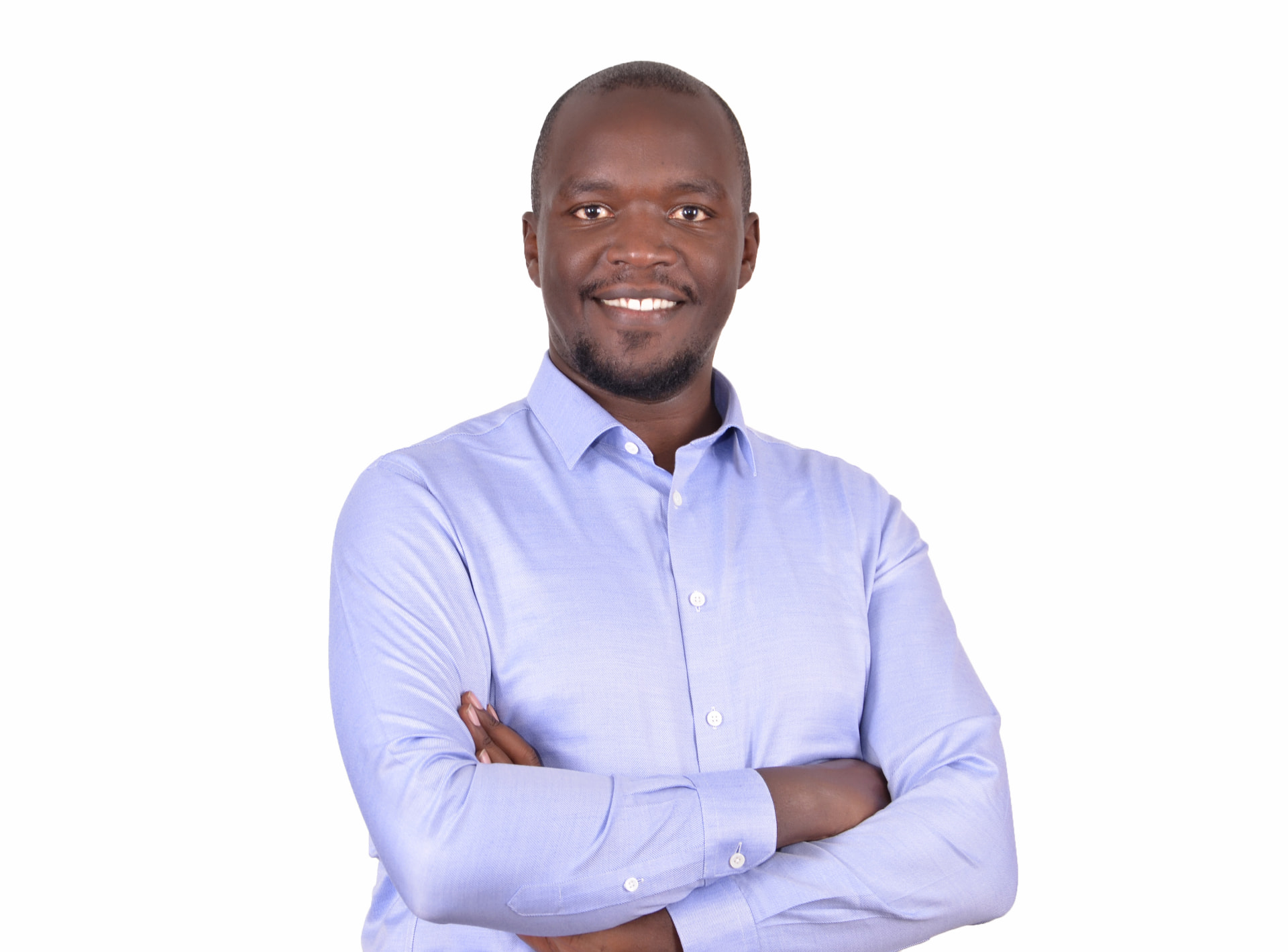 Brian Karoney standing with arms folded in a professional studio portrait