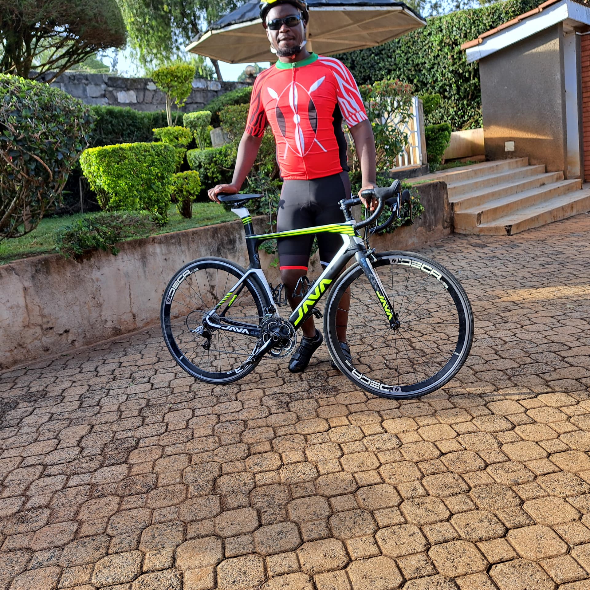 Brian in a red cycling jersey with his Java road bike